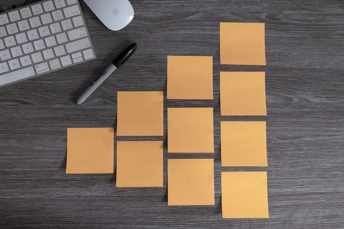 Orange sticky notes organized on a desk